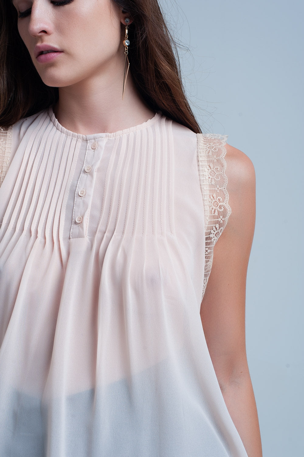 Beige sleeveless top with lace details