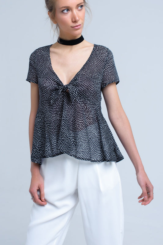 Q2 Black polka dot top with ruffle hem