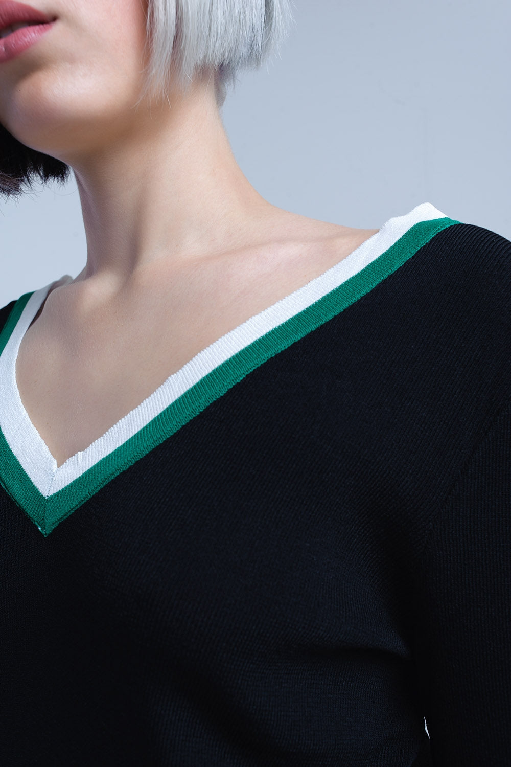 Black V-neck jersey with green and white contrast trim