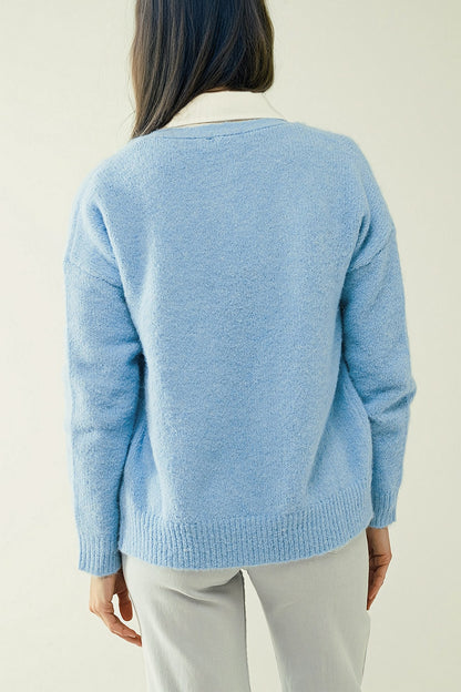 Blue knit cardigan with wide V-neck and button closure