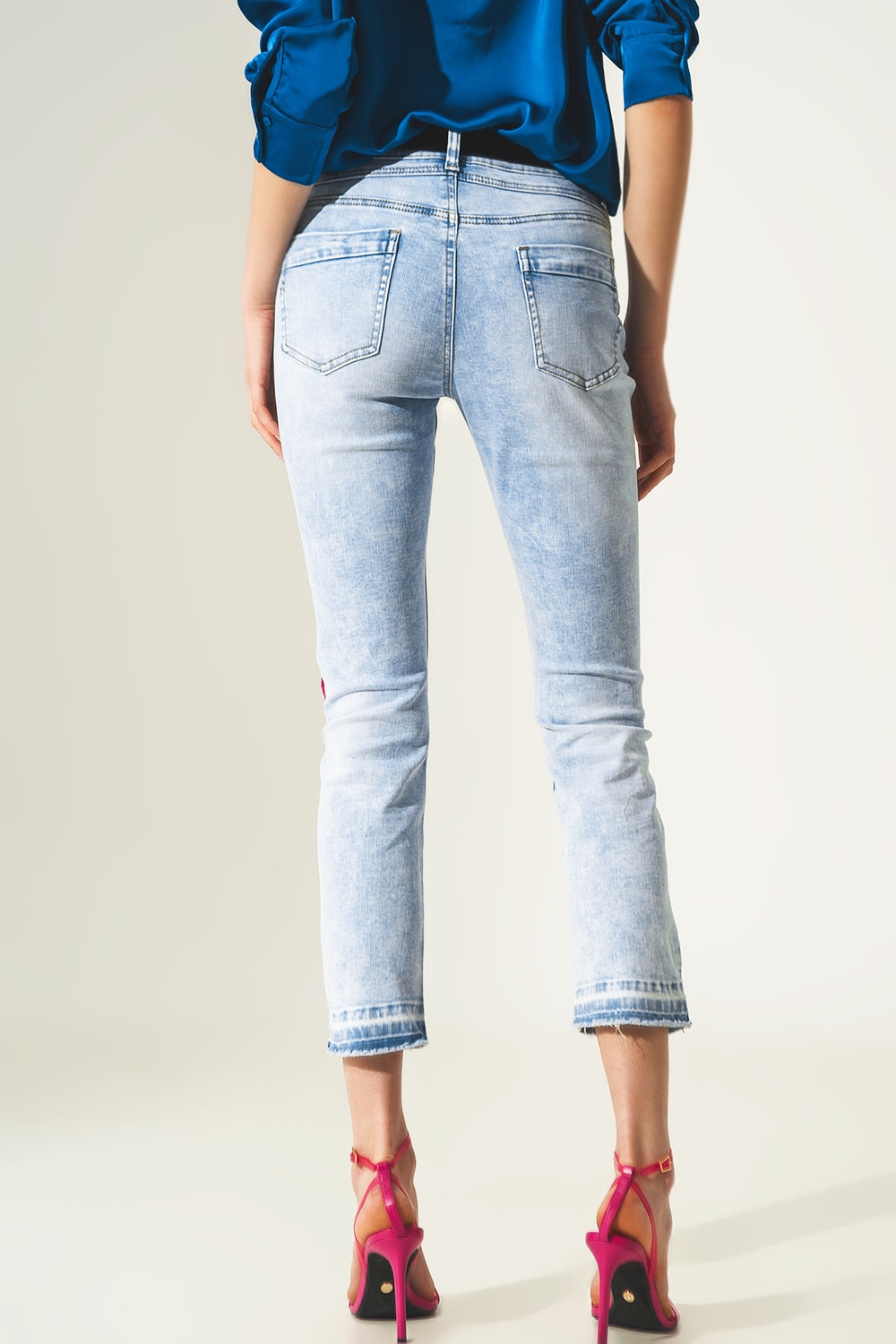 Distressed straight jeans with hem detail in blue