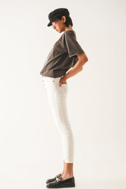 Exposed buttons skinny jeans in cream