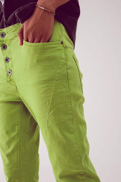 Exposed buttons skinny jeans in green