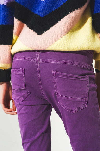 Exposed buttons skinny jeans in purple