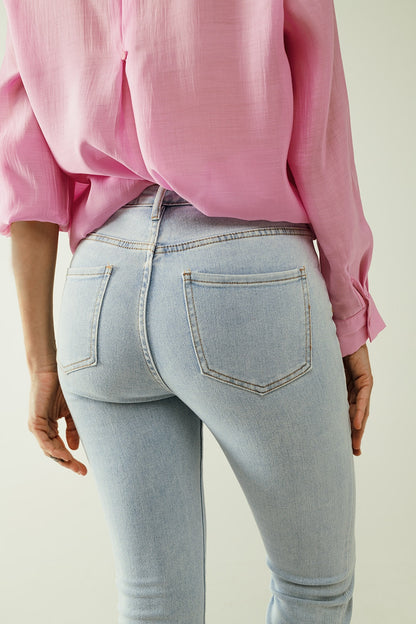 Flared light blue jeans with five pockets and seamless finish