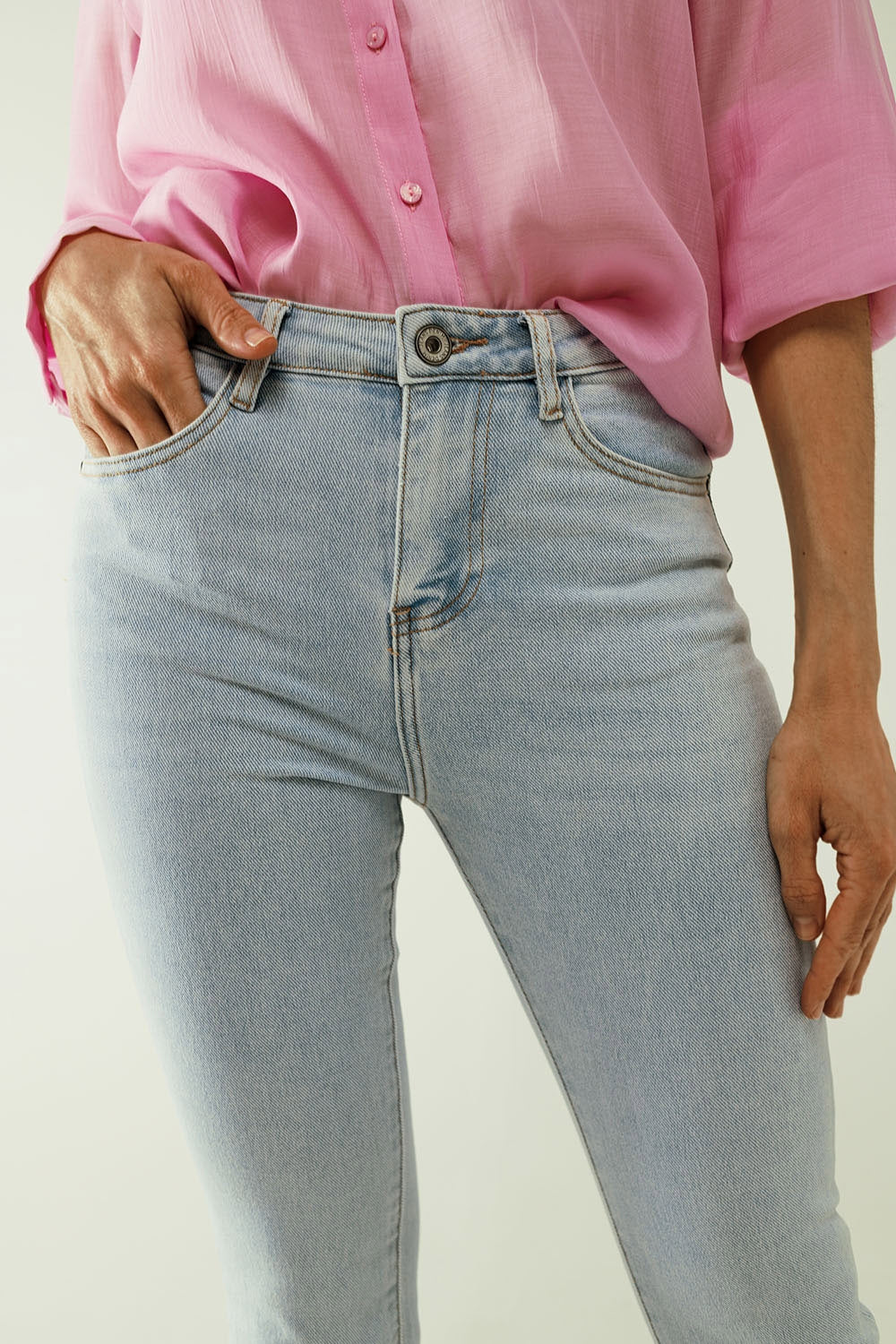 Flared light blue jeans with five pockets and seamless finish