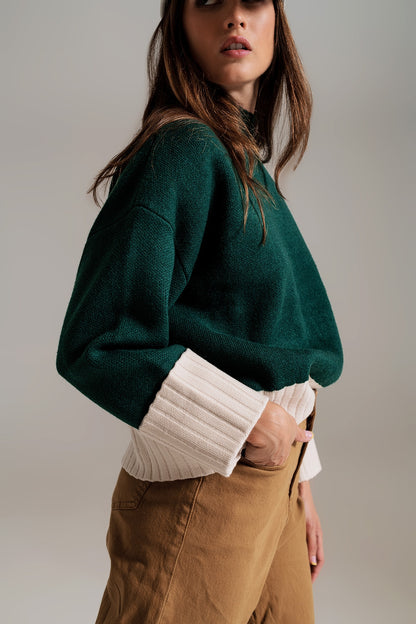 green jumper with white ribbed cuffs and hem