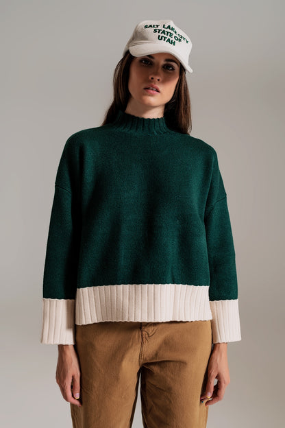 green jumper with white ribbed cuffs and hem