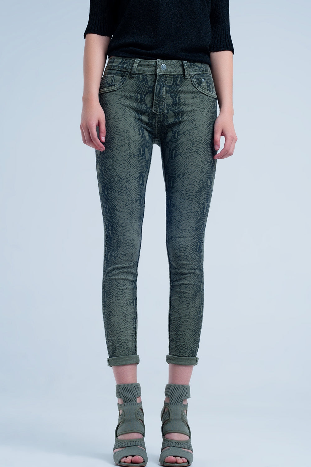 Green skinny reversible jeans with snake print