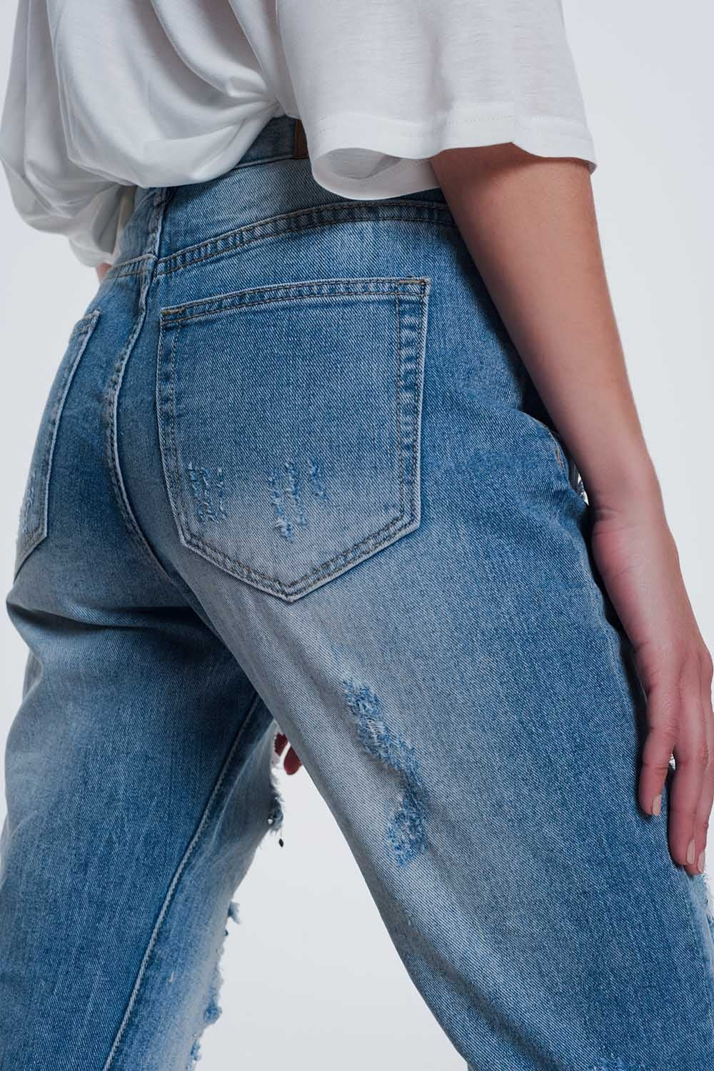 Heavily torn straight jeans in light denim