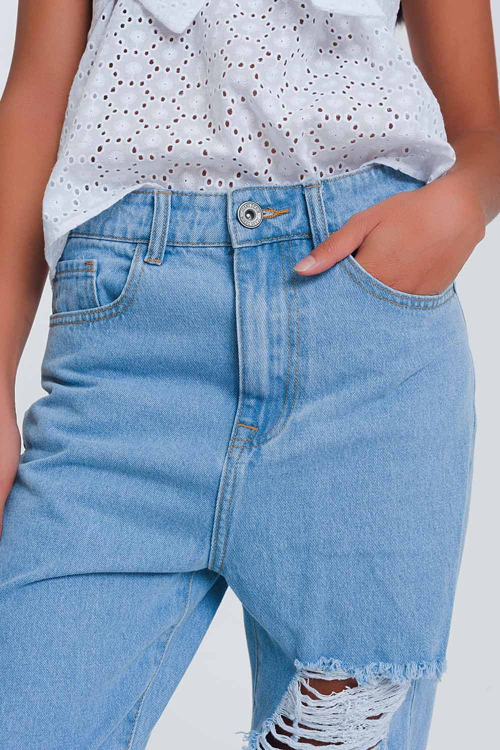 High waist mom jeans with busted knees in light denim