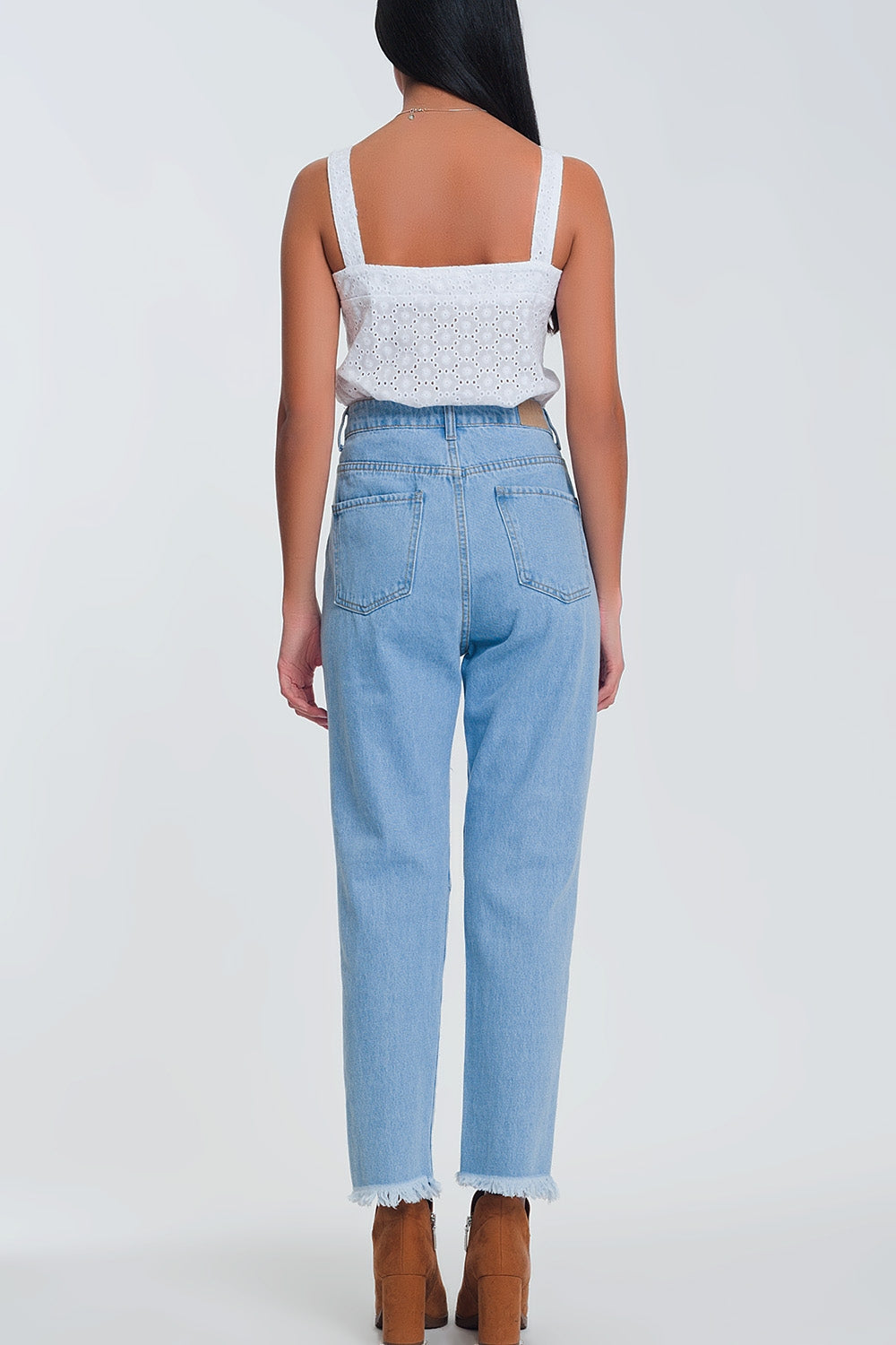 High waist mom jeans with busted knees in light denim