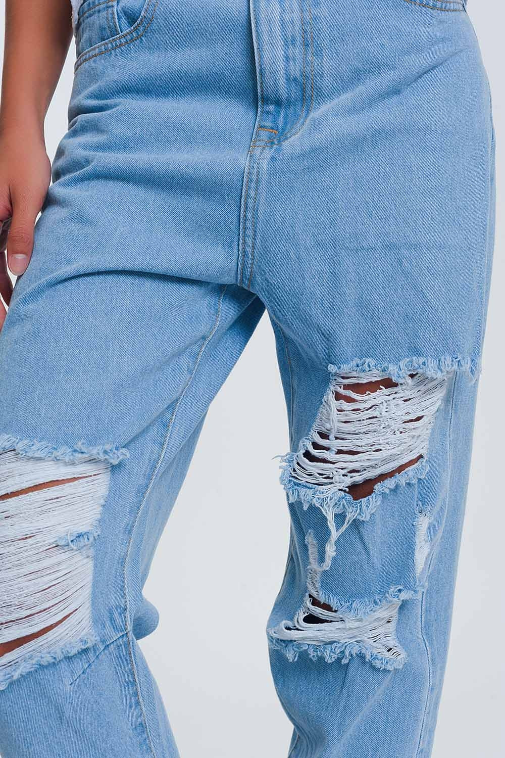 High waist mom jeans with busted knees in light denim