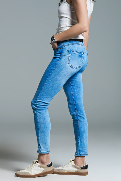 Light blue basic skinny jeans with short slit at hem