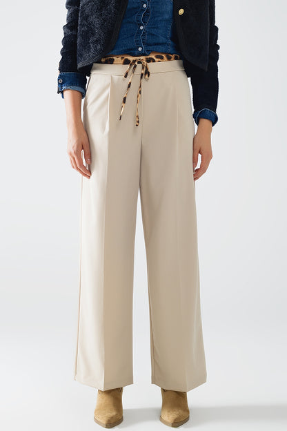 Q2 Long beige pleated trousers with leopard detail at the waist