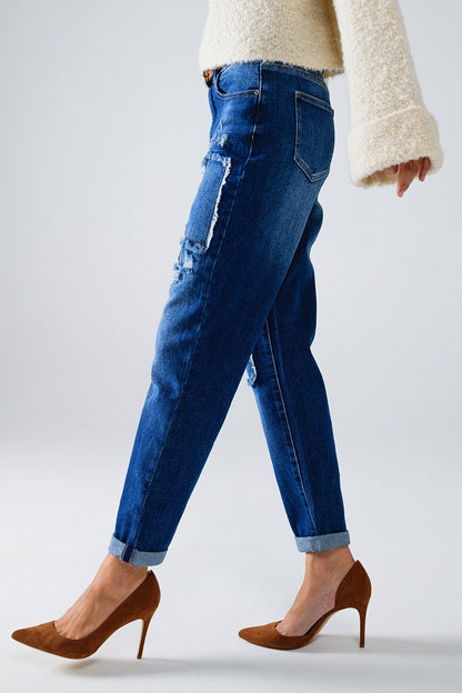 Loose blue jeans with subtle ripped design and patches