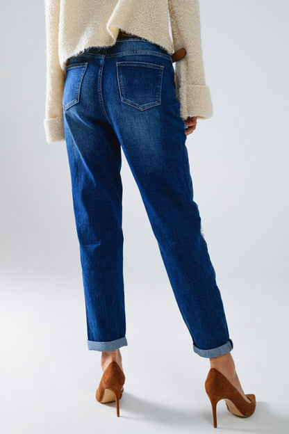 Loose blue jeans with subtle ripped design and patches