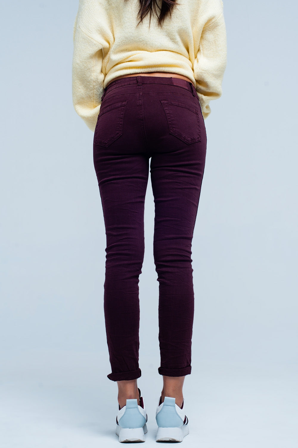 Maroon skinny jeans with metal side stripe