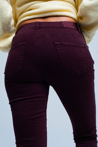 Maroon skinny jeans with metal side stripe