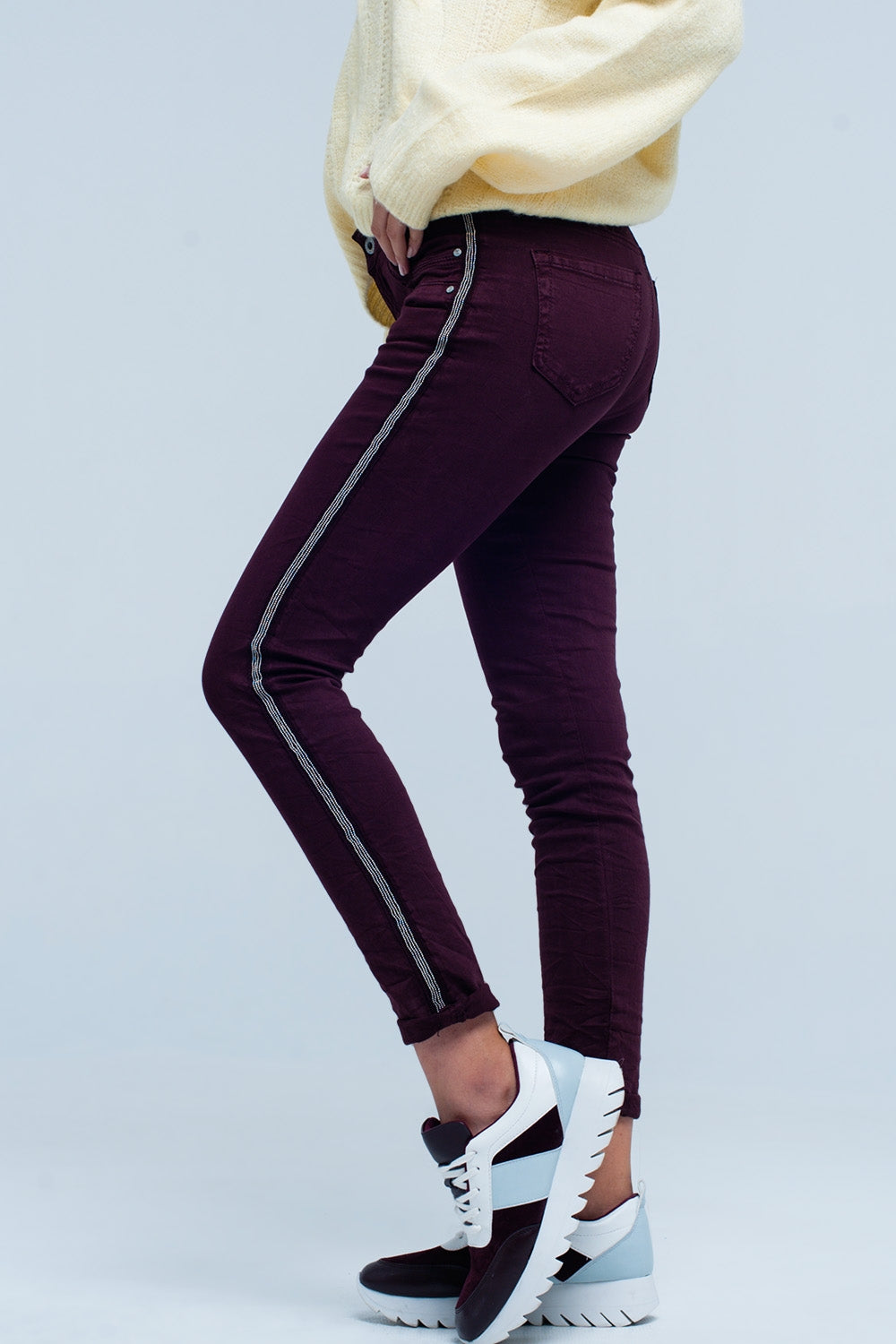 Maroon skinny jeans with metal side stripe